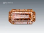 Emerald-cut rutile-included quartz, 10.40 carats, showing golden rutile needles within a clear faceted gemstone from Pakistan.