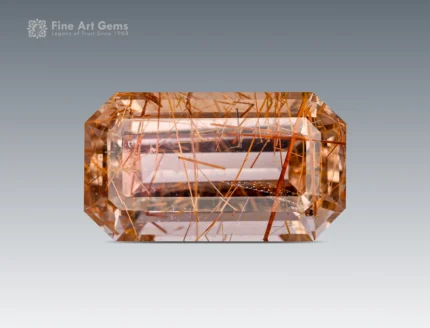 Emerald-cut rutile-included quartz, 10.40 carats, showing golden rutile needles within a clear faceted gemstone from Pakistan.