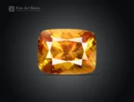 Fine 2-carat faceted sphene gemstone with gemmy golden-yellow color, cushion cut, and strong brilliance from Pakistan.