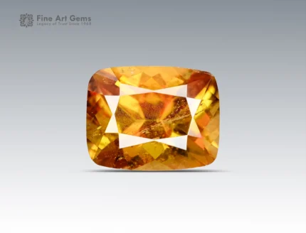 Fine 2-carat faceted sphene gemstone with gemmy golden-yellow color, cushion cut, and strong brilliance from Pakistan.