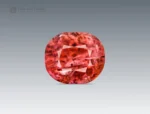 Cushion-cut vayrynenite gemstone from Pakistan displaying rosy red to raspberry color with natural internal features.