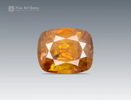 Faceted cushion-cut sphene gemstone with warm golden-orange color and gemmy brilliance from Pakistan.