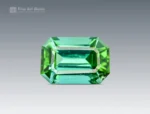 Emerald cut tourmaline gemstone showing blue and green tones with clean facet structure