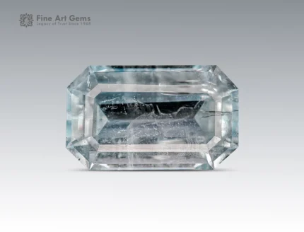 Natural emerald cut aquamarine gemstone with light blue color and visible inclusions from Pakistan.