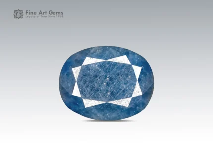 12.95 ct oval cut blue sapphire gemstone from Madagascar showing pink fluorescence under UV light