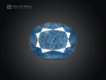 12.95 ct oval cut blue sapphire gemstone from Madagascar showing pink fluorescence under UV light